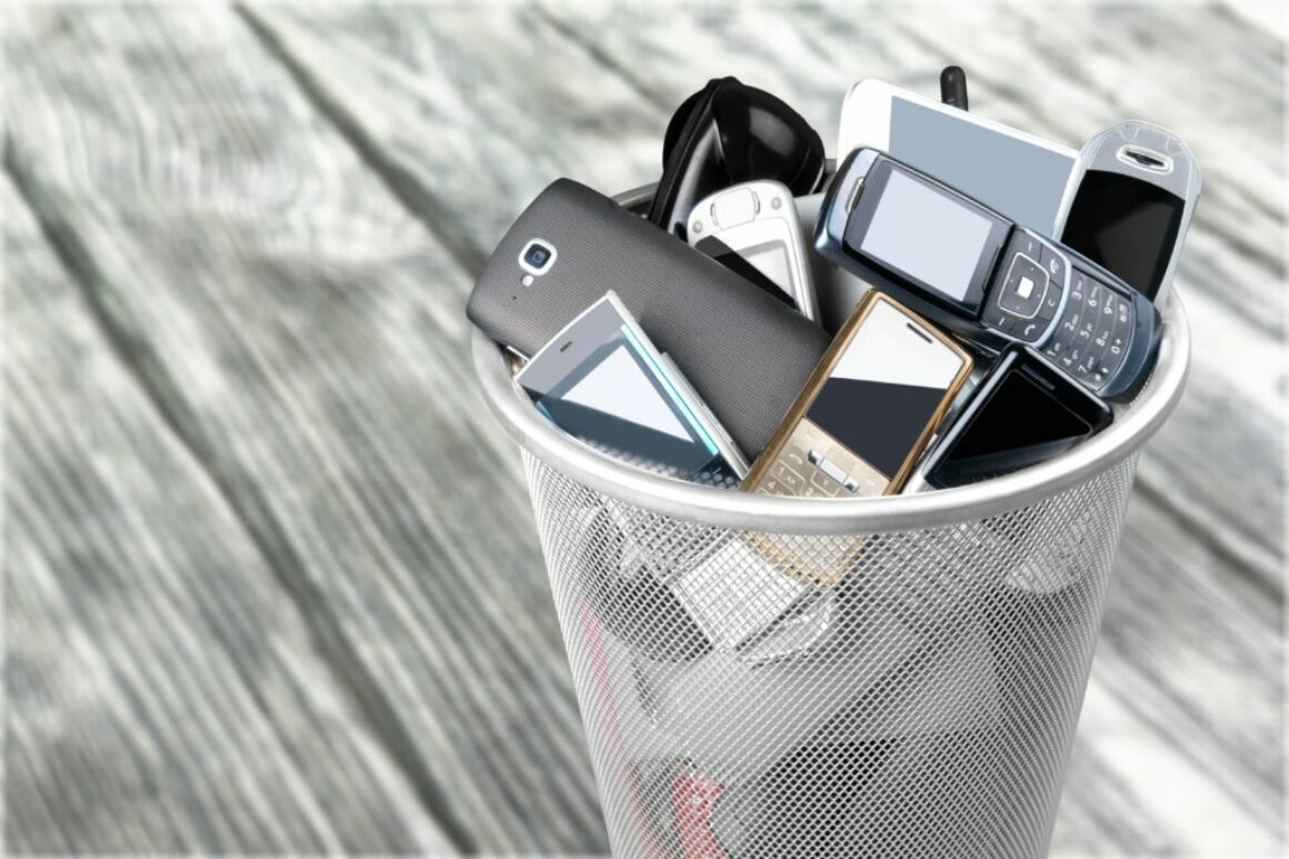 Rubbish bin full of old cellphones