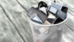 Rubbish bin full of old cellphones