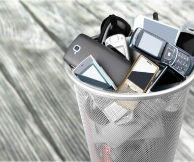 Rubbish bin full of old cellphones